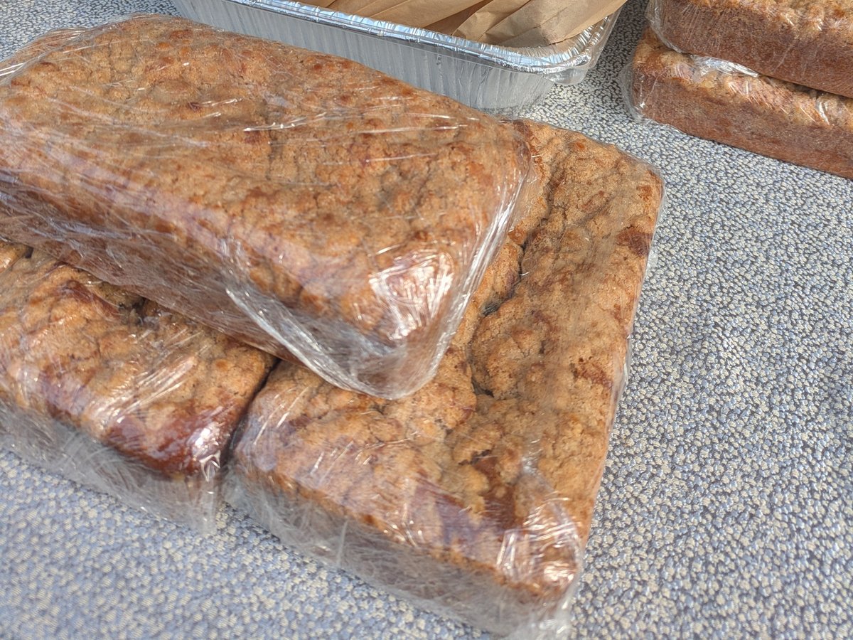 Coffee cake loaves wrapped and stacked on the table at the market